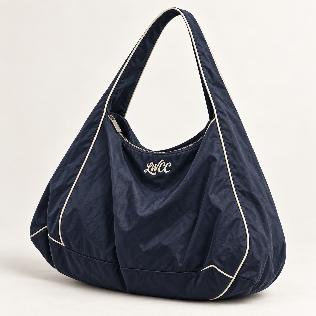 Oversized midnight navy crinkle nylon shoulder bag with cream piping and embroidered LWCC script