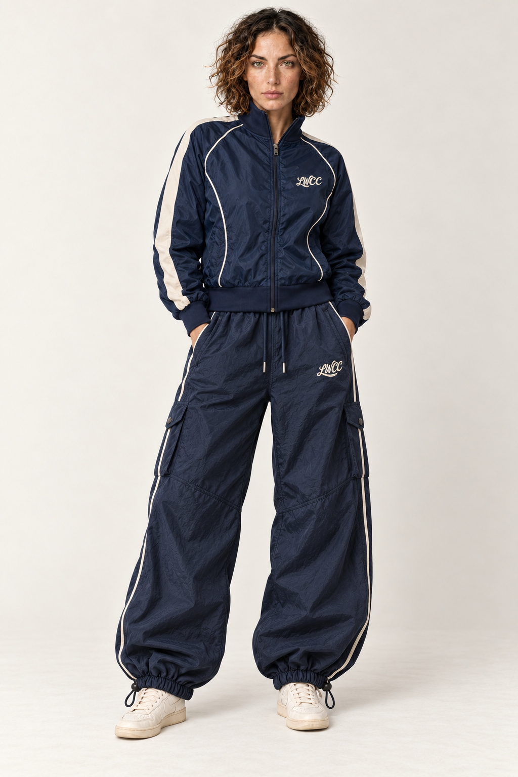 Lost Wight model wearing navy parachute trousers and Court Piping shell jacket