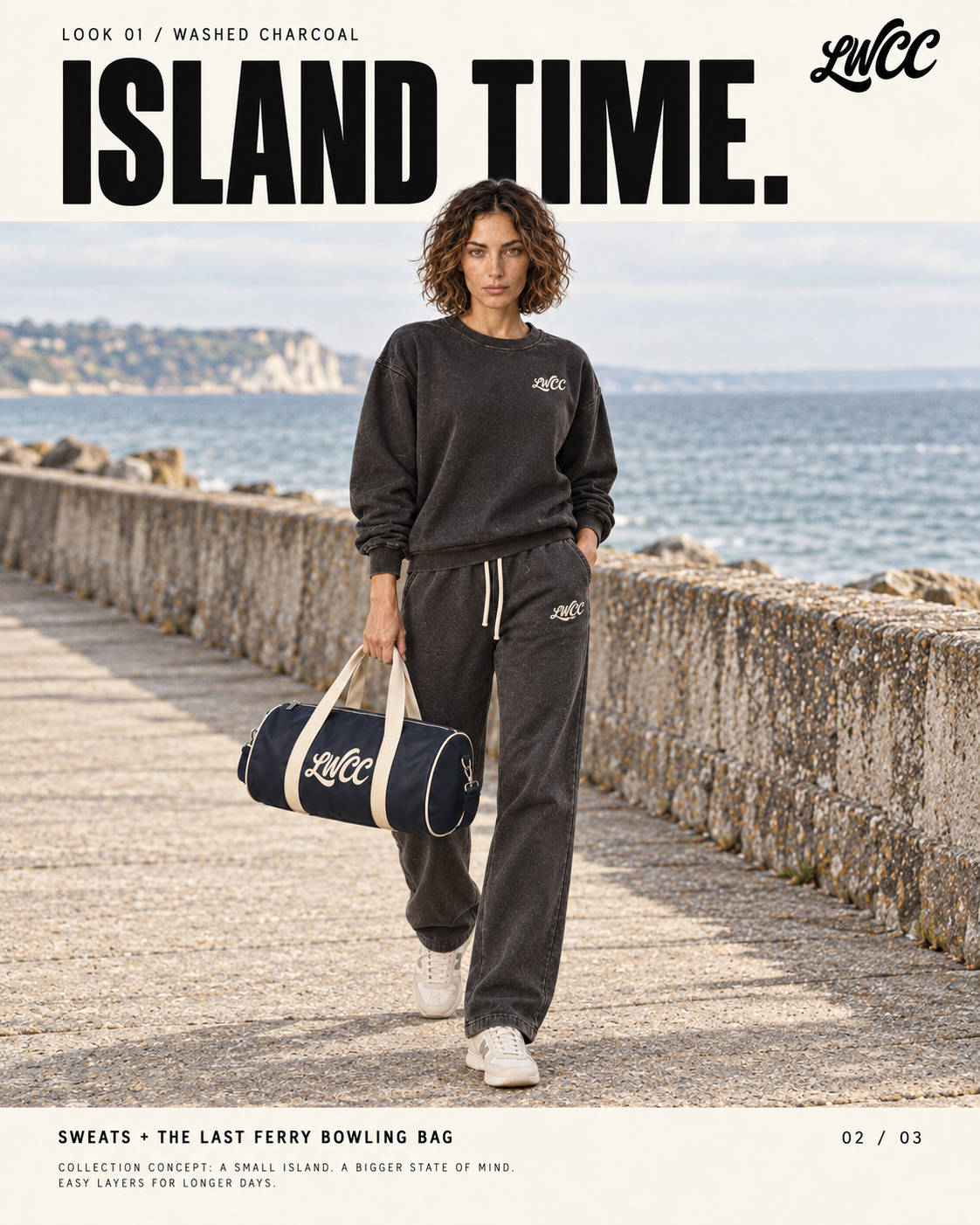 The model walking on a seaside promenade in charcoal sweats carrying the navy and cream bowling bag.